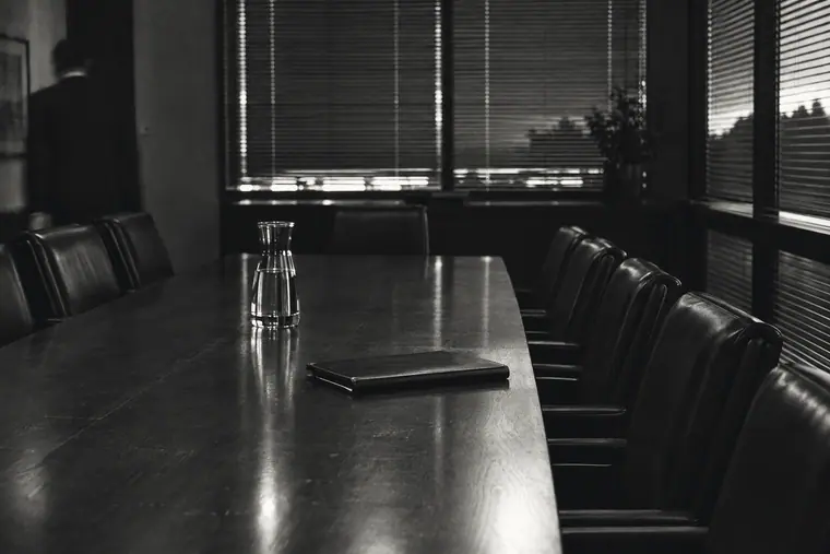 An empty conference room with a long table after hours.